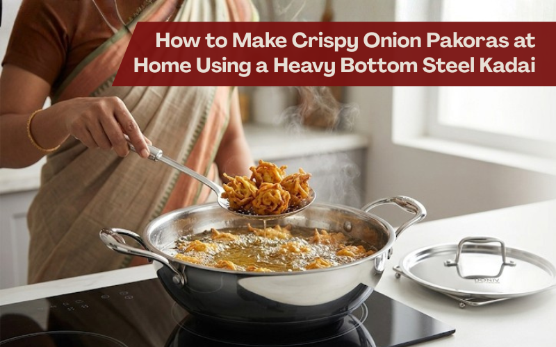 Indian woman frying crispy onion pakoras in a heavy-bottom stainless steel kadai, lifting freshly fried pakodas from hot oil with a slotted ladle in a bright modern kitchen.