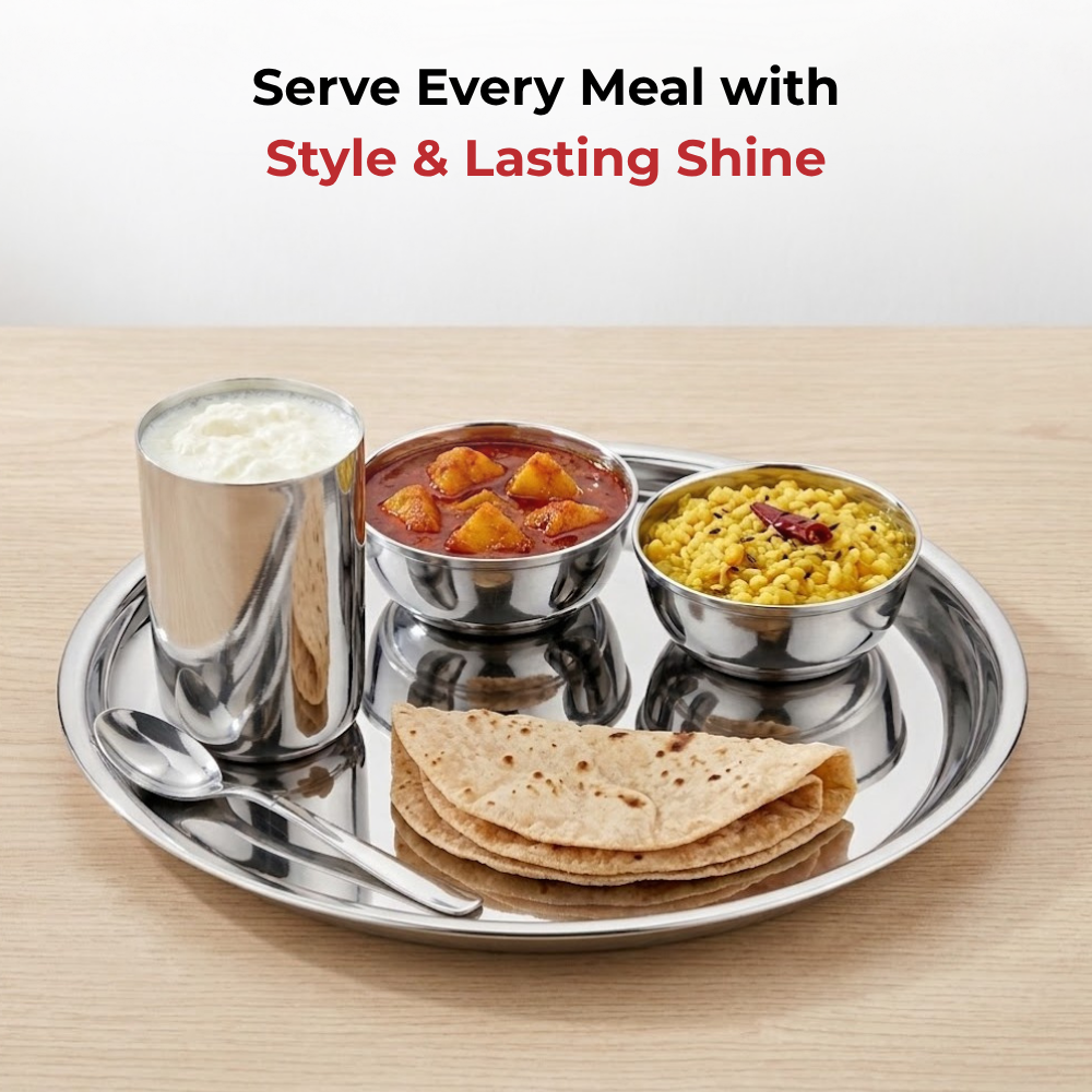 A stainless steel Indian meal set on a round tray, including a cup of milk, a bowl of vegetable curry, a bowl of rice, folded flatbread, and a spoon, displayed on a light wood surface with promotional text above.